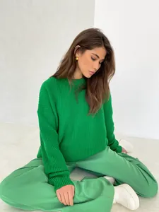 Close-up detail of a vibrant green round neck loose-fit knit sweater for stylish women