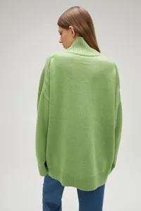 Back view detail of a lime green oversized high-neck knit sweater for fall and winter