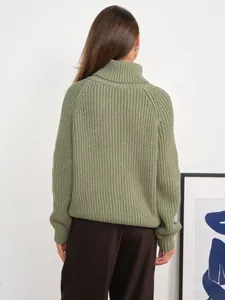 Back view of a thick green turtleneck chunky knit sweater for women