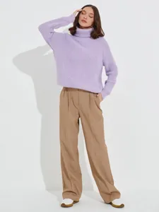 Detailed shot of a stylish thick lavender turtleneck knitted sweater for winter fashion