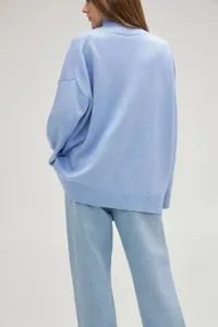 Detailed back view of a light blue high-neck oversized knit sweater for autumn winter