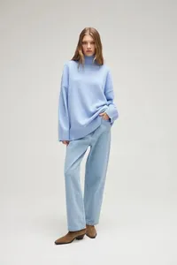 Cozy light blue oversized turtleneck sweater paired with denim jeans for autumn look