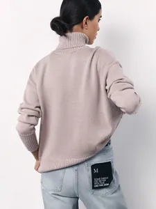 Detailed back view of a cozy loose-fitting pink turtleneck sweater for autumn winter