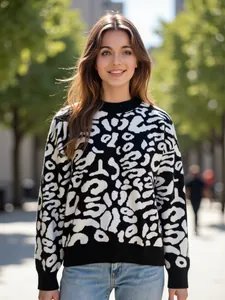 Close-up of a stylish leopard print mock neck sweater on a smiling model outdoors