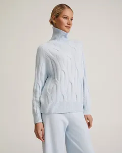 Detailed view of women's light blue turtleneck cable knit sweater and matching pants set