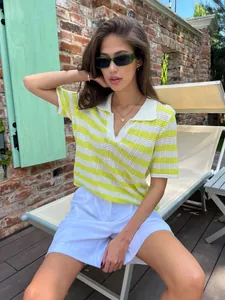 Stylish yellow and white striped polo collar knit top worn by a model in a summer setting
