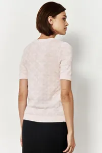 Back view of pink short-sleeve knit sweater featuring a geometric diamond texture