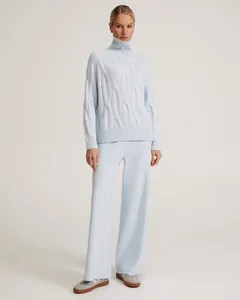Full length view of light blue turtleneck cable-knit sweater and wide-leg pants set