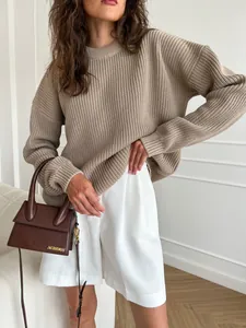 Detail view of women's taupe oversized ribbed knit sweater with round neck design
