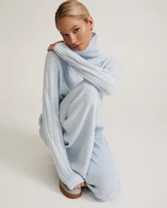 Close-up of a premium light blue high neck knitted two-piece sweater and pants set for women