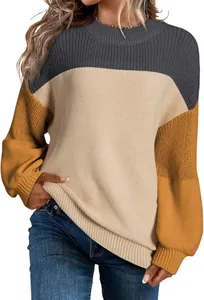 Close-up detail of women's color-block knit sweater featuring trendy lantern sleeves