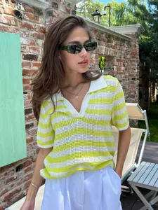 Women's yellow and white striped short-sleeved knit Polo sweater in lifestyle outdoor setting