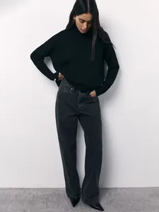 Close-up of a cozy black oversized turtleneck sweater for women in winter.