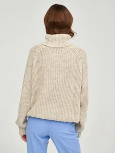 Back view detail of a beige oversized turtleneck knit sweater with thick texture