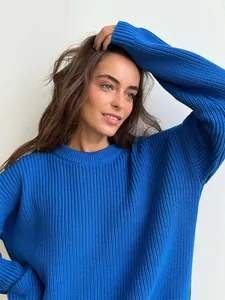 Detailed view of women's chunky knit crew neck sweater in vibrant blue color