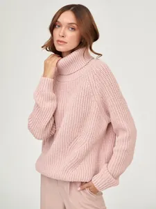 Detailed view of soft pink chunky knit turtleneck sweater for autumn and winter