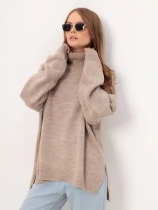 Detail view of a loose taupe turtleneck sweater with side slits and ribbed texture.