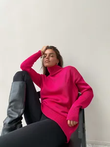 Stylish woman wearing oversized hot pink turtleneck sweater and black leather boots