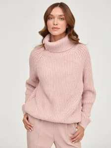 Detail view of a cozy pink chunky knit turtleneck sweater for autumn and winter