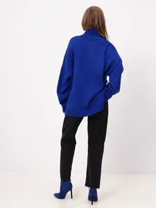 Detailed back view of a cozy royal blue oversized turtleneck knit sweater for women