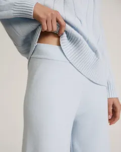 Macro view showing the soft knit texture and elastic waist of a light blue two-piece set