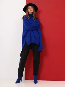 Professional model wearing a vibrant blue oversized turtleneck knit sweater for winter