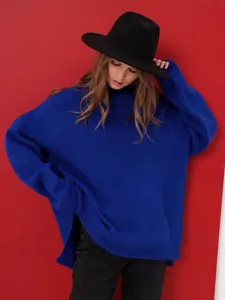 Detailed view of the blue oversized high-neck knit sweater's texture and loose fit