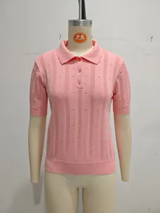 Detailed view of a pink short-sleeved polo knit sweater featuring elegant pointelle patterns