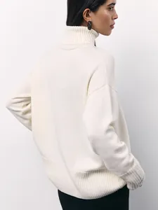 Detailed back view of a cozy cream oversized turtleneck knitted sweater for women