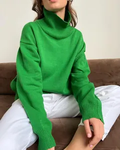 Close-up detail of a thick green oversized turtleneck knit sweater for autumn/winter.