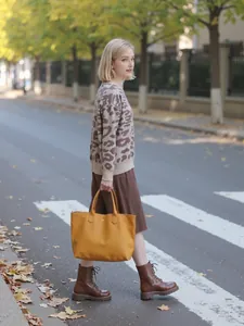 Model wearing a stylish leopard print mock neck knitted sweater in an autumn street setting