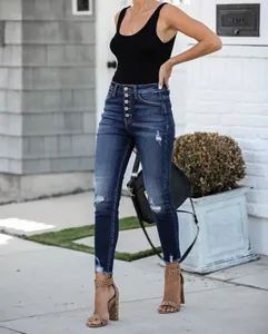 Full-length view of distressed high-waisted skinny jeans with button fly detail