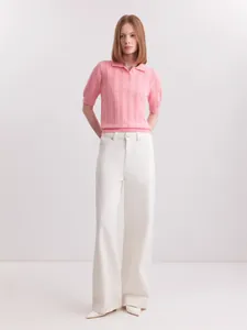 Elegant pink short-sleeved knit polo shirt paired with stylish white wide-leg trousers