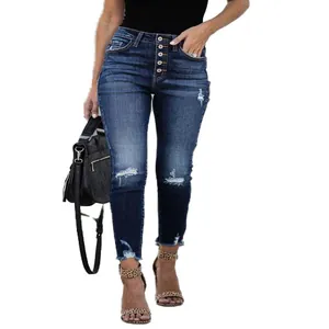 Full-length view of women's high-waisted distressed skinny jeans with retro button fly