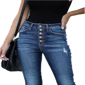 High-waisted slim fit blue denim jeans featuring a five-button fly and distressed ripped detail.