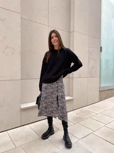 Elegant loose fit black round neck knit sweater for women styled with leopard skirt