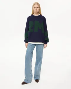 Vorderansicht dunkelblauer Rundhals-Strickpullover mit grünem Buchstabendruck und Jeanshose