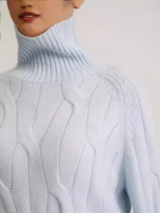Elegant light blue high-neck knitted sweater featuring classic cable knit texture and loose fit