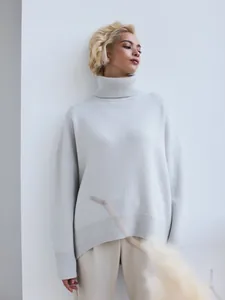 Oversized light grey turtleneck knit sweater with ribbed cuffs for a cozy winter look