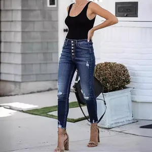 High-waisted button-fly ripped skinny jeans with frayed hems in vintage dark blue