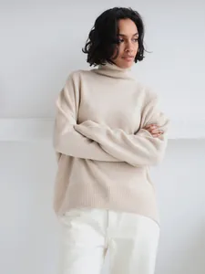 Model wearing a cozy beige oversized turtleneck knit sweater for autumn winter fashion