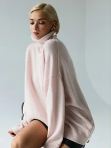 Cozy oversized pale pink turtleneck knit sweater for women, premium soft texture.