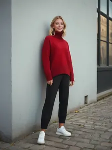 Cozy red turtleneck thickened knitted sweater styled with black joggers in urban street scene