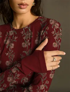 Detail view of vintage floral print and fabric texture on a slim-fit knit top