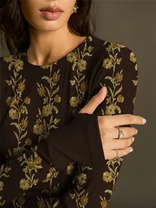 Close-up detail of vintage floral print on a dark brown slim-fit knit long-sleeve tee
