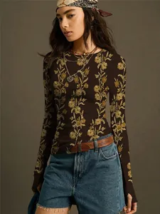 Close-up view of a vintage floral print on a dark brown slim-fit knitted long-sleeve T-shirt