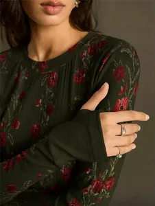 Detail of retro floral print on dark green slim-fit knitted long sleeve T-shirt