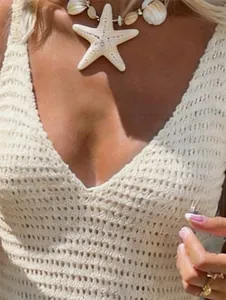 Close-up view of a cream crochet knit dress with V-neckline for summer beach fashion