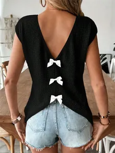 Close-up of black waffle knit T-shirt featuring deep V-back with white bow accents