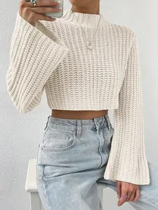 Detail of a beige cropped sweater featuring wide bell sleeves and ribbed knit texture.